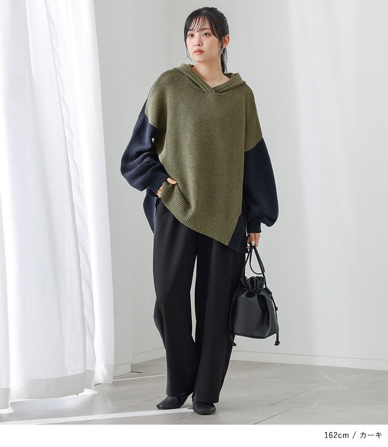 カーキ×ネイビーのバイカラーニットパーカーに黒のワイドパンツと巾着バッグを合わせた、洗練された休日タウンコーデ。
