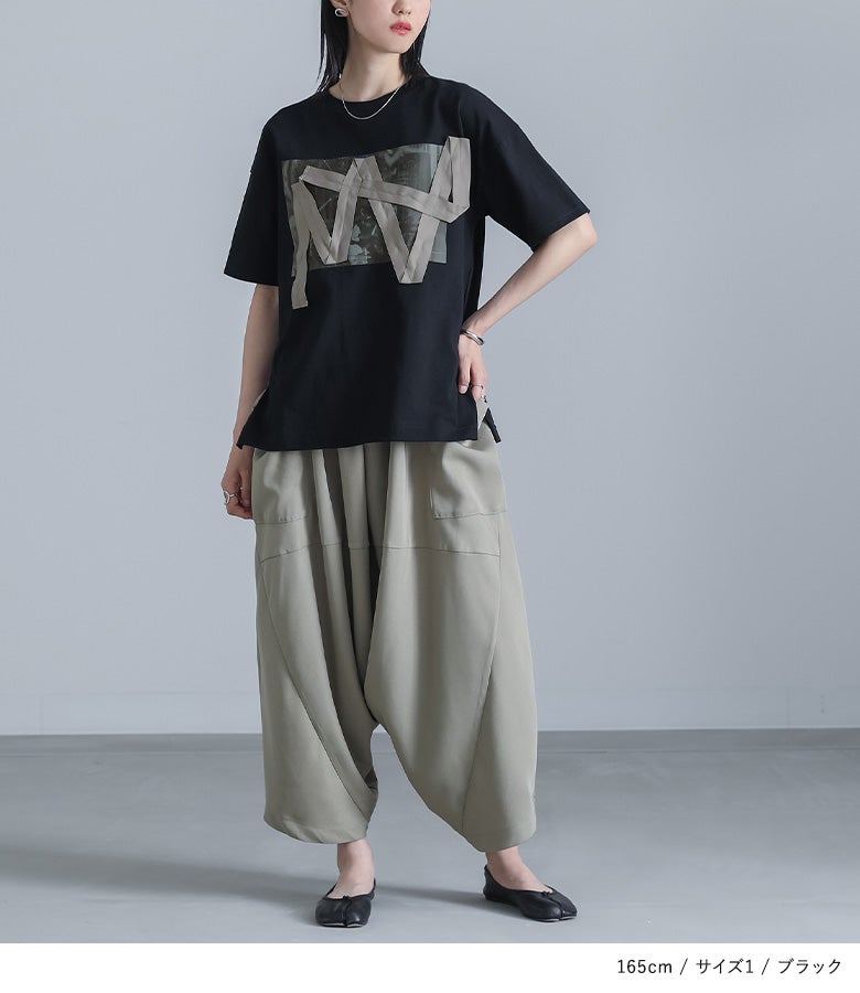 ブラックのテープデザイン半袖Tシャツにカーキのサルエルパンツを合わせた、モード感あふれる大人の休日お出かけコーディネート。ゆったりとしたシルエットでリラックス感と個性を両立したスタイリングです。