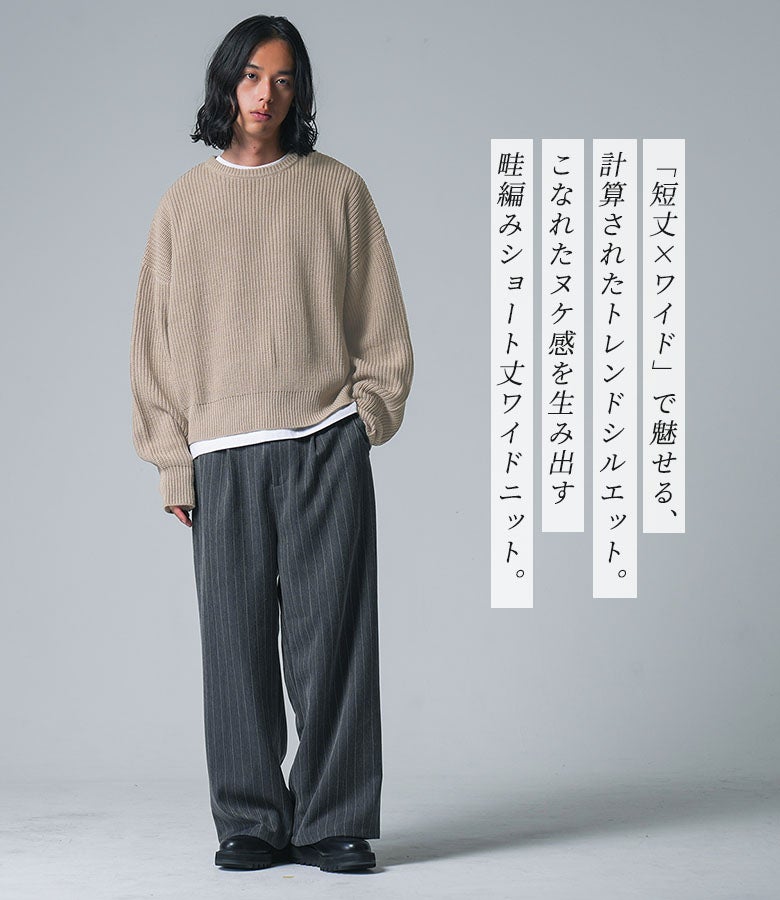 短丈×ワイドのバランスでトレンド感を演出するベージュのショート丈畦編みニット。チャコールグレーのストライプ柄ワイドパンツと合わせた、こなれ感漂う大人カジュアルコーデ。