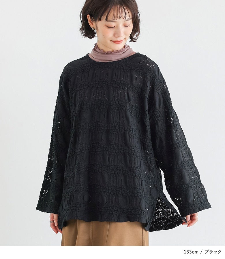 ブラックの総レーストップスにピンクのシアーハイネックを合わせたレイヤードスタイル。首元や裾のスリットから覗くインナーの差し色がシックな黒レースに映え、手軽におしゃれなこなれ感を演出します。