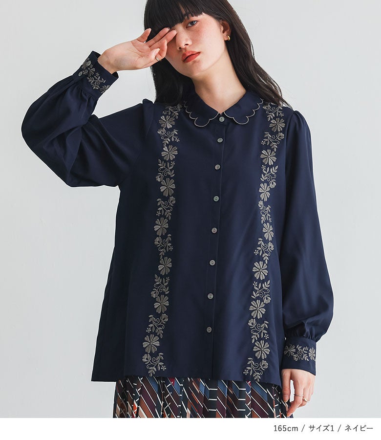 ネイビーの花柄刺繍スカラップ襟ブラウスに幾何学柄プリーツスカートをあわせたシックな大人きれいめコーディネート。オフィスカジュアルや秋のお出かけシーンに重宝するクラシカルな装いです。
