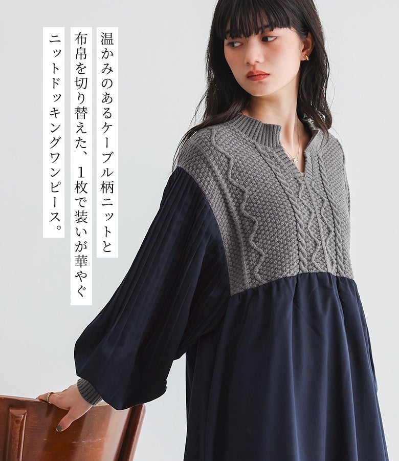 温かみのあるケーブル柄ニットと布帛を切り替えた異素材ドッキングワンピース。深みのあるグレーのニットとネイビーの生地を組み合わせた、秋冬のおでかけやデイリー使いに重宝する上品な一着です。