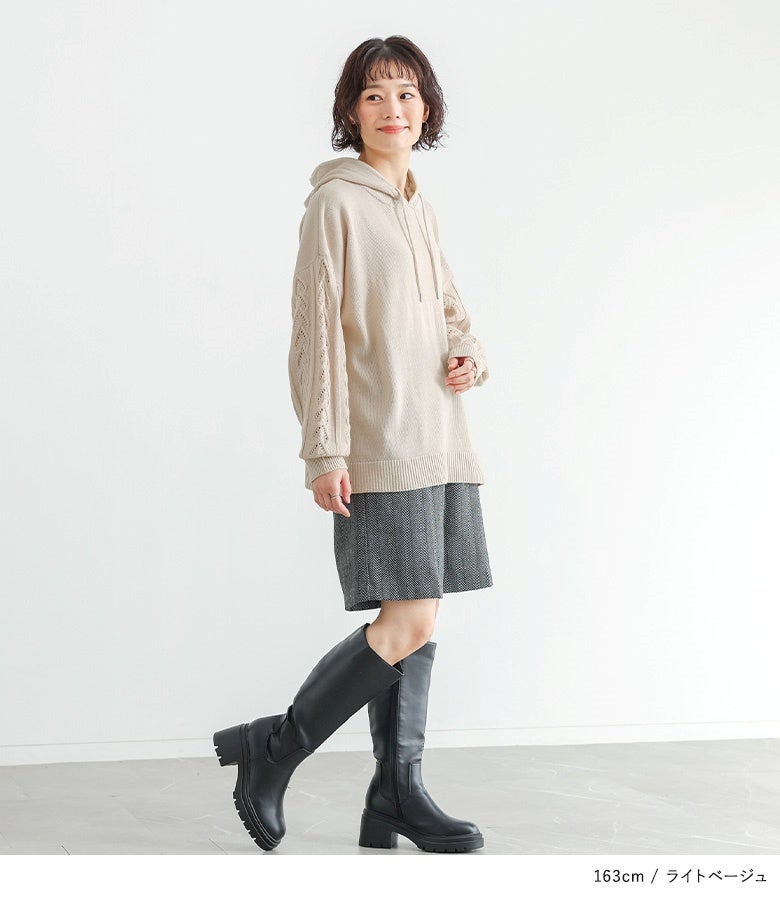 明るく優しい印象を与えるライトベージュの柄編みぽわん袖ニットパーカー。ショートパンツやロングブーツとの相性も抜群の大人可愛い着こなしです。